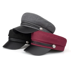 Three wool newsboy caps in black, grey and burgundy with faux leather brims and silver buttons