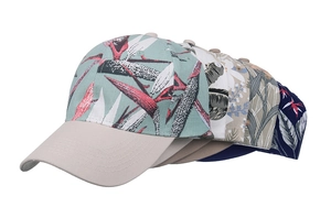 Detail view of five baseball caps with tropical floral patterns and solid curved brims