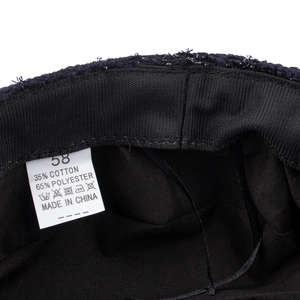 Interior view of black beret with breathable mesh sweatband and size 58 polyester label