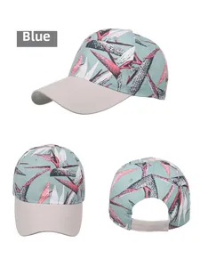 Detail view of tropical leaf print baseball cap with mint green base and grey brim textures