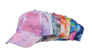 Detail of colorful tie-dye patterns on cotton baseball caps showing vibrant fabric texture