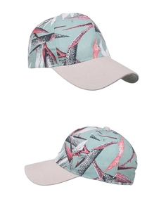 Detail of tropical palm leaf print and contrast brim on mint green baseball cap