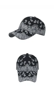 Detail view showing black and white paisley pattern on cotton baseball cap fabric