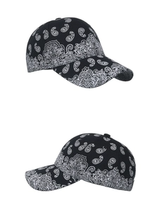 Detailed side view of two black baseball caps featuring white paisley floral prints