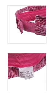 Detail of striped sun visor featuring adjustable velcro strap and wash care label