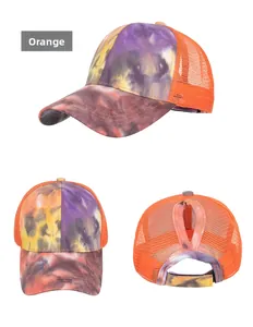 Detailed view of tie-dye baseball cap with orange mesh back and high ponytail hole opening