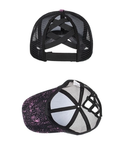 Detail of cross elastic bands on mesh ponytail baseball cap with pink splatter design