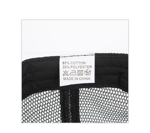 Detail view of the care label inside a black mesh baseball cap showing 65% cotton fabric