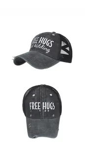 Detailed view of embroidery and distressed holes on mesh back baseball cap in grey