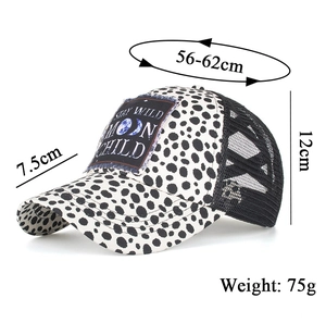 Detail view of dalmatian print baseball cap with STAY WILD MOON CHILD patch embroidery