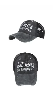 Detail view of distressed grey mesh baseball cap with Hot Mess embroidery and frayed edges
