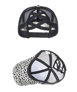 Detail view of criss-cross elastic bands on a ponytail mesh baseball cap with leopard print