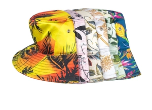 Detail view of tropical print bucket hats featuring metal eyelets and vibrant patterns