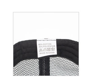 Close-up of black mesh trucker hat interior with quality stitching and 65% cotton fabric label