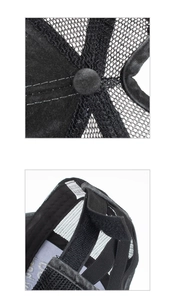 Detail of adjustable velcro strap and wash label on black mesh baseball cap