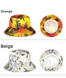 Detail view of orange palm tree and beige floral pattern wide brim sun hats