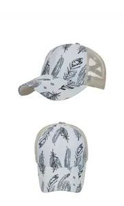 Detail view of khaki mesh trucker hat featuring white front panel and feather print