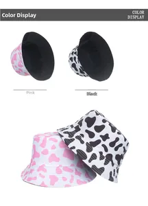 Flat lay showing pink and black cow print bucket hats with interior lining detail