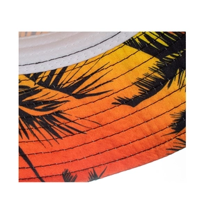 Detailed close-up of tropical palm tree pattern on sun hat brim with parallel stitching