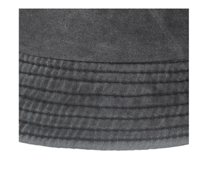 Macro shot of parallel stitching and washed cotton texture on a dark grey bucket hat