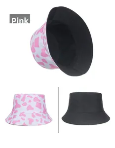 Detail showing the reversible pink cow print and black cotton wide brim sun hat