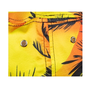 Detail view of tropical palm leaf print fabric with dual black stitching and silver eyelets