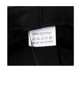 Macro view of the 100% cotton material label and care instructions for the sun hat