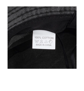 Detail view of cotton sun hat inner label showing 100 percent cotton material and care symbols