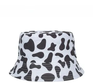 Close-up of black and white cow print bucket hat with durable canvas stitching detail