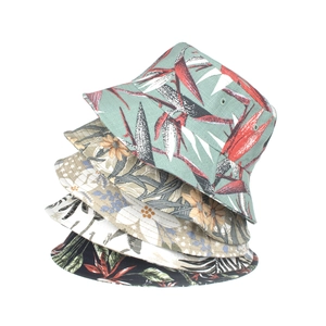Floral cotton bucket hats with tropical palm leaves and hibiscus patterns for sun protection