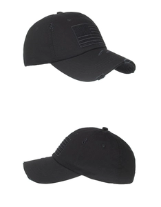 Detail of distressed black baseball cap featuring tonal American flag embroidery