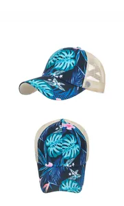 Detail view of navy blue ponytail baseball cap with tropical floral print and mesh back