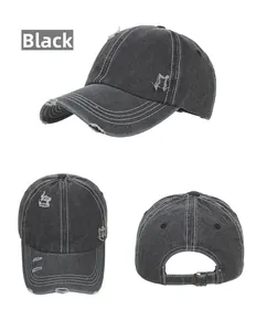 Detail of black washed cotton baseball cap with distressed holes and metal buckle