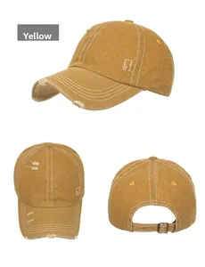 Detail view of mustard yellow washed canvas baseball cap with distressed rip effects
