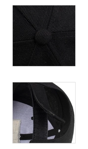 Detailed view of the black baseball cap showing the stitching, crown, and adjustable strap