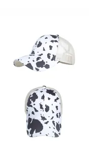 Detail view of cow print mesh trucker hat with breathable fabric and adjustable back