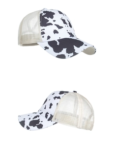 Detailed view of cow print mesh baseball cap with breathable beige net and adjustable back