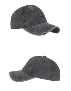 Close-up of washed grey ponytail baseball cap with vintage distressed ripped details