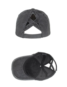 Detail view of the elastic X-cross ponytail design and inner cotton label of the baseball cap