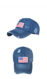 Dettaglio del berretto da baseball in denim lavato con patch USA ed effetto usurato