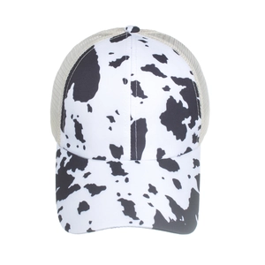 Cow print trucker hat with criss-cross elastic ponytail hole and breathable mesh back
