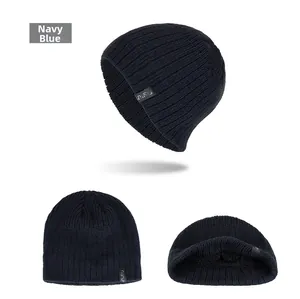 Detail showing navy blue ribbed knit beanie with FASHION woven label and thick texture