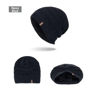 Detail of navy blue knitted beanie showing thick black fleece lining and wavy texture
