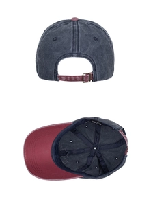Detail of the adjustable metal buckle and embroidered maple leaf on a vintage cotton cap