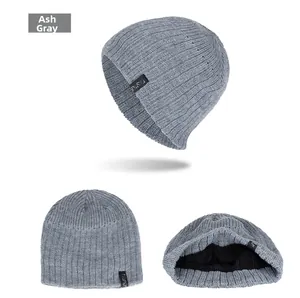 Detail of heather grey knit beanie showing ribbed texture and warm black fleece lining