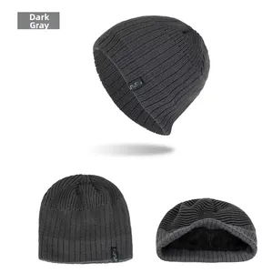 Detail of dark grey knitted beanie showing thick texture and warm black fleece lining