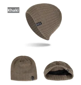 Detail view of khaki knitted beanie with FASHION label and warm fleece lining