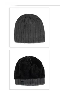 Detail view of dark grey knitted beanie with thick black plush fleece lining for winter warmth