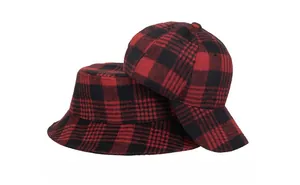 Close-up of red and black buffalo plaid fabric texture on winter baseball and bucket hats