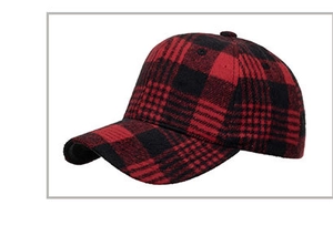 Detailed view of red and black buffalo plaid fabric on a warm autumn baseball cap